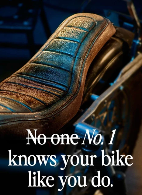 Close-up of a weathered motorcycle seat with visible stitching detail, complemented by a dark, moody background and typography overlay.
